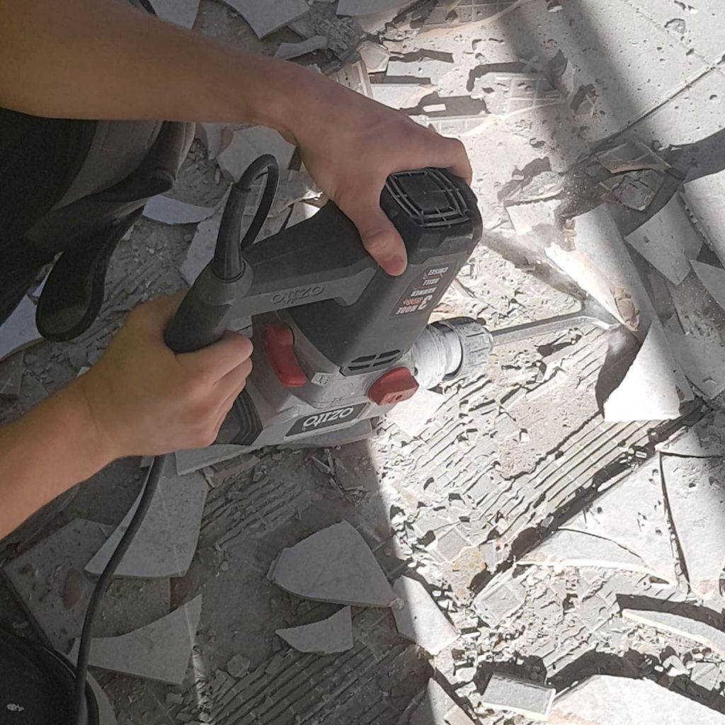 The Image is Showing Our Team Member Removing Tiles