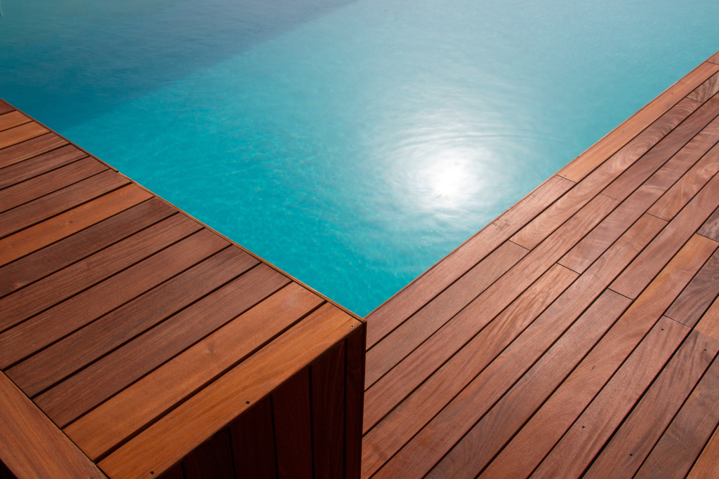 diagonal,lines,of,wood,in,detail,decking,and,blue,water